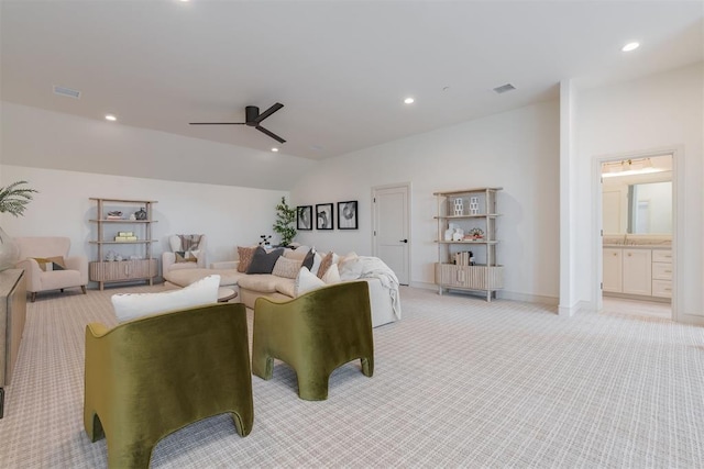 carpeted living room featuring ceiling fan and lofted ceiling