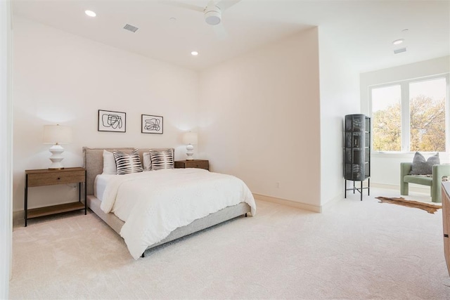 bedroom featuring light carpet and ceiling fan