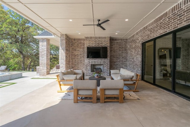 view of patio with an outdoor living space with a fireplace and ceiling fan