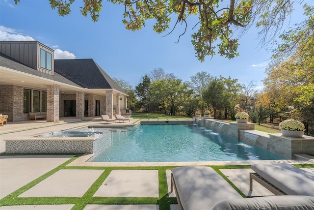 pool featuring a patio area and an in ground hot tub