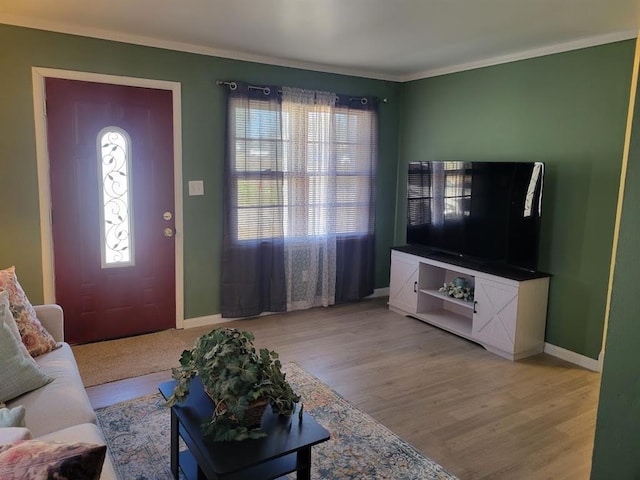 living room with light hardwood / wood-style flooring and ornamental molding