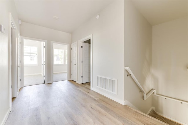 corridor with light wood-type flooring