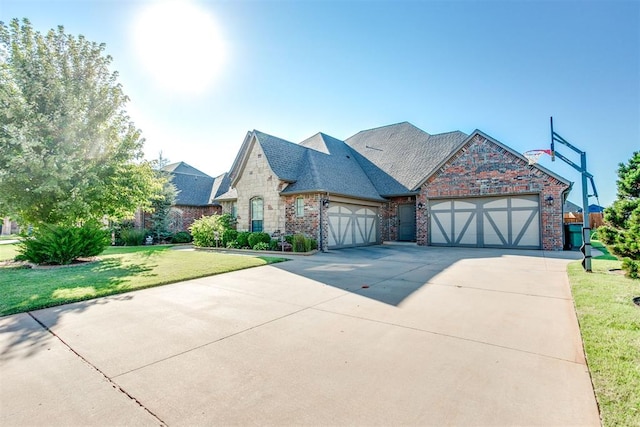 view of front of house with a garage and a front lawn