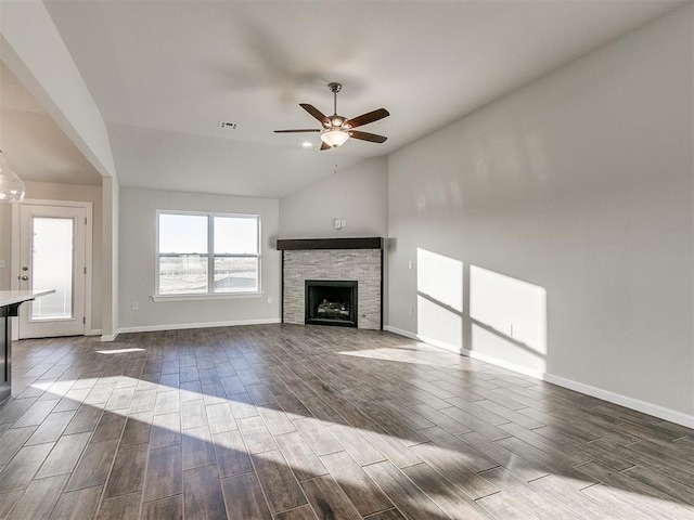 unfurnished living room featuring a fireplace, dark hardwood / wood-style flooring, ceiling fan, and lofted ceiling