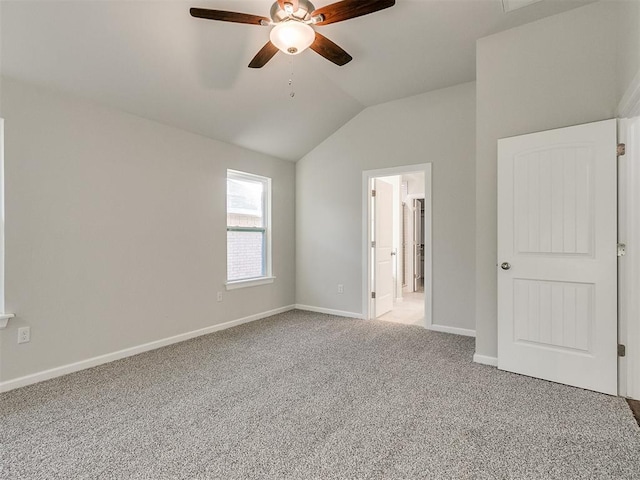 unfurnished bedroom featuring carpet flooring, ceiling fan, lofted ceiling, and connected bathroom