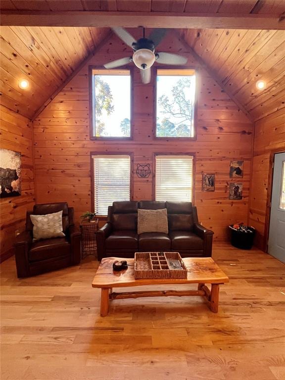 living room with wood ceiling, wooden walls, lofted ceiling with beams, and light wood-type flooring