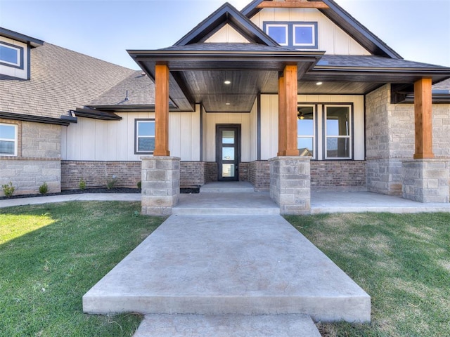 doorway to property featuring a yard and covered porch