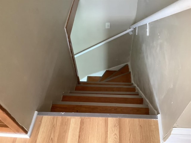 stairway with hardwood / wood-style flooring