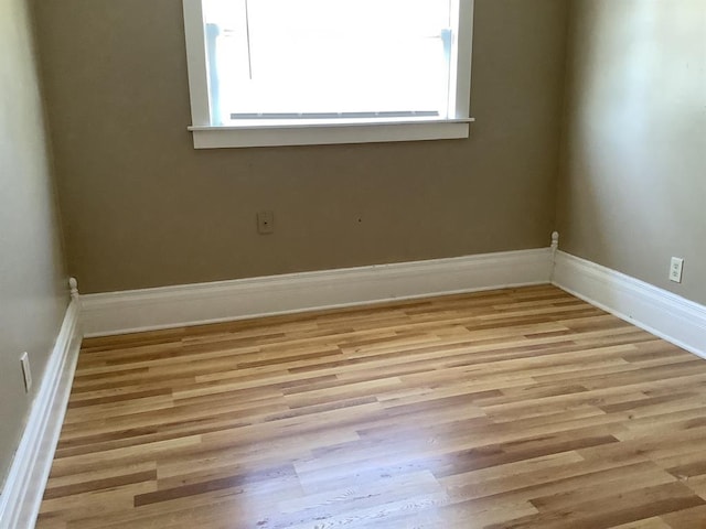 unfurnished room with light wood-type flooring