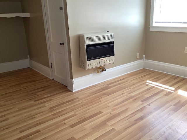 details with heating unit and hardwood / wood-style flooring