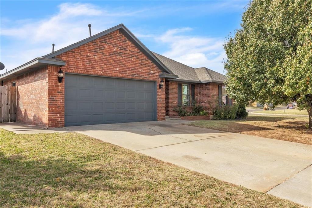 single story home with a front yard and a garage