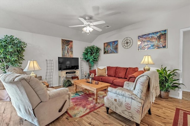 living room featuring lofted ceiling, ceiling fan, and light wood-type flooring