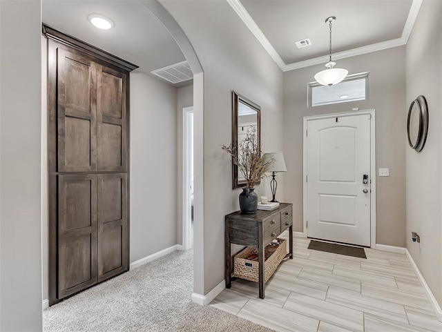 entryway featuring light carpet and crown molding