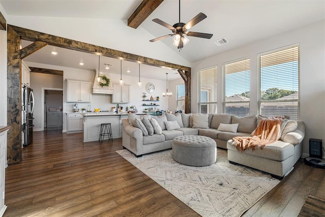 living room featuring ceiling fan with notable chandelier, lofted ceiling with beams, and dark hardwood / wood-style floors