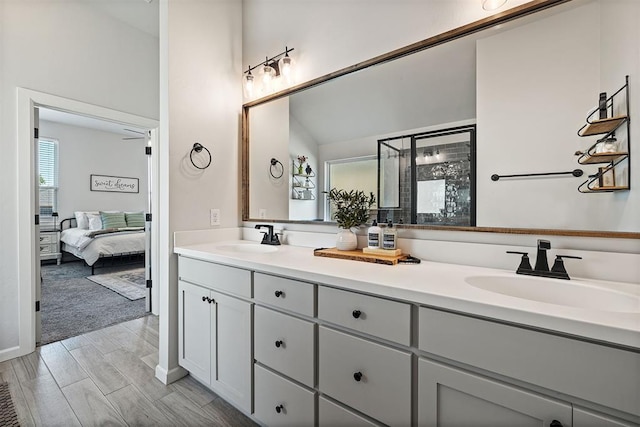 bathroom with hardwood / wood-style flooring, vanity, and a shower with door