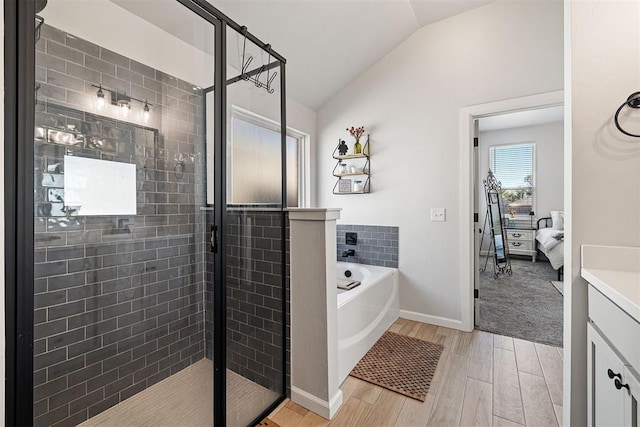 bathroom with vanity, wood-type flooring, lofted ceiling, and independent shower and bath