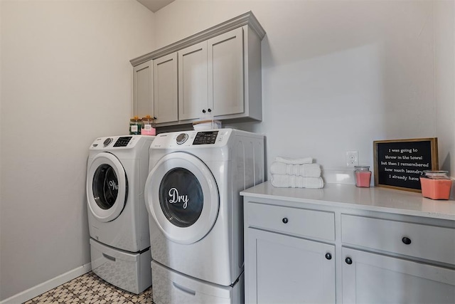 laundry area with cabinets and washing machine and clothes dryer