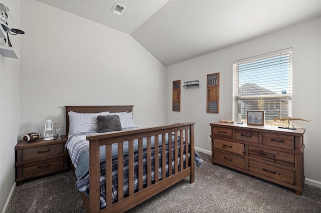 bedroom with dark carpet and lofted ceiling