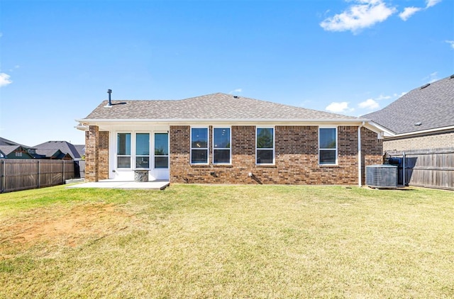 back of house with a lawn, a patio area, and central AC