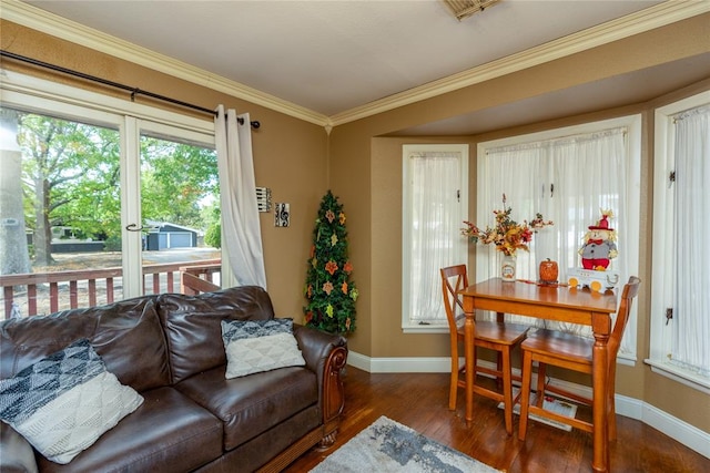 living room with dark hardwood / wood-style flooring, plenty of natural light, and ornamental molding