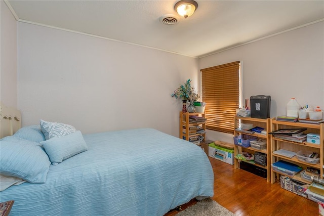 bedroom featuring crown molding and hardwood / wood-style floors