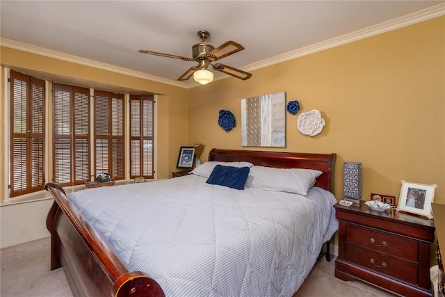 carpeted bedroom with ceiling fan and crown molding