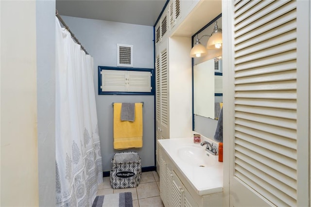 bathroom featuring tile patterned flooring and vanity