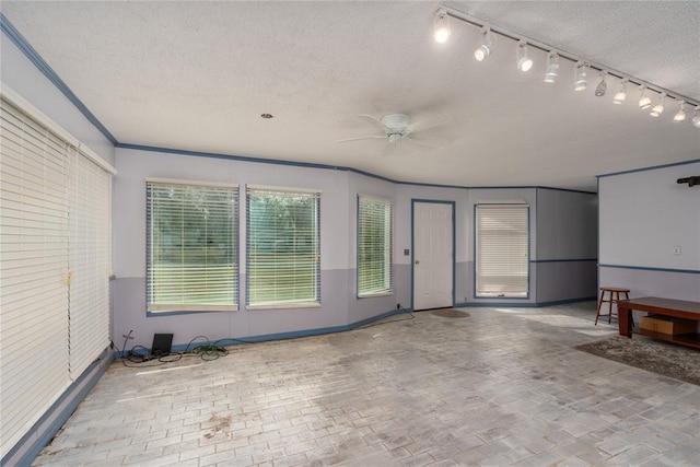 interior space with ceiling fan