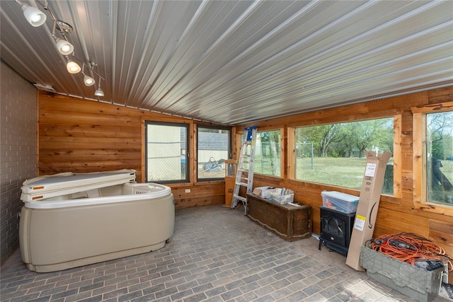 sunroom with lofted ceiling, a wealth of natural light, and wooden ceiling