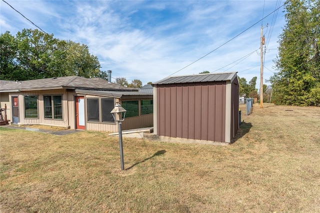 exterior space with a lawn and a storage shed