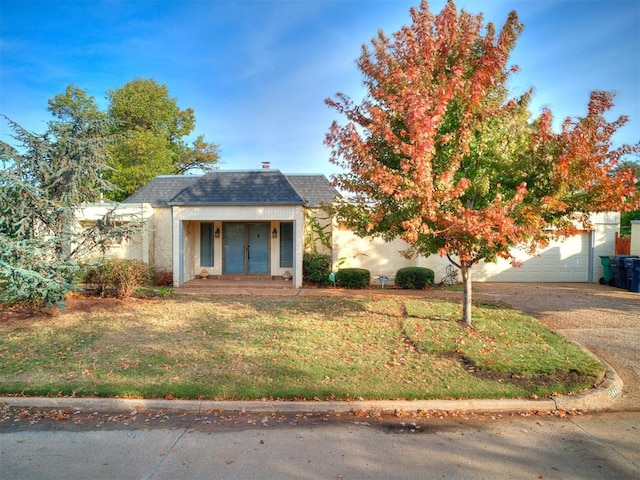 obstructed view of property with a front yard and french doors