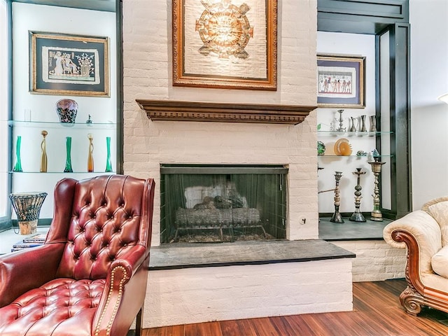 living area featuring hardwood / wood-style flooring and a fireplace