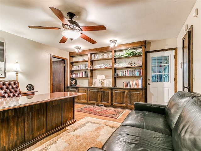 office with ceiling fan and light hardwood / wood-style floors