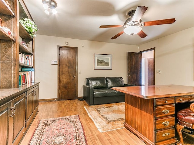 home office with ceiling fan and light wood-type flooring