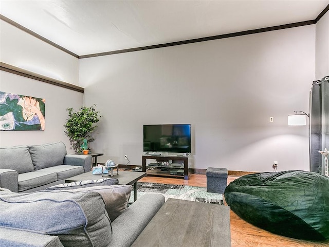 living room with crown molding and hardwood / wood-style floors