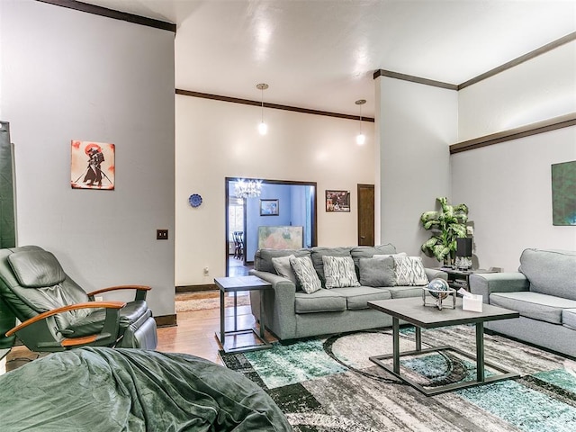 living room featuring crown molding, hardwood / wood-style floors, and an inviting chandelier