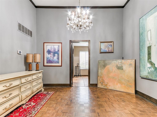 interior space with a chandelier, light parquet floors, and crown molding