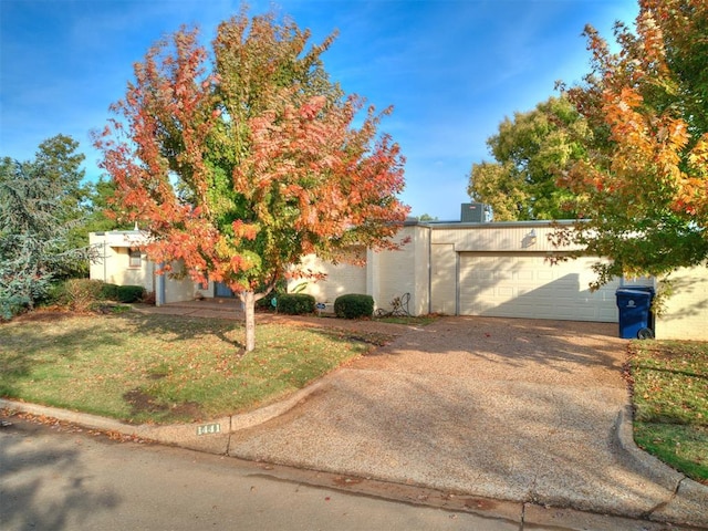 obstructed view of property with a garage