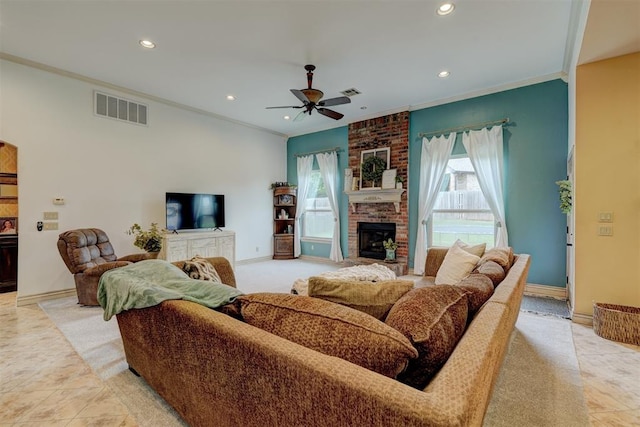 living room with ceiling fan, a fireplace, light tile patterned floors, and ornamental molding