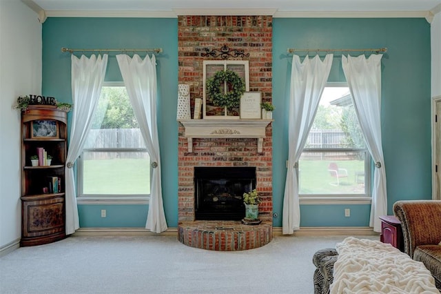 living area with a fireplace, carpet, and ornamental molding