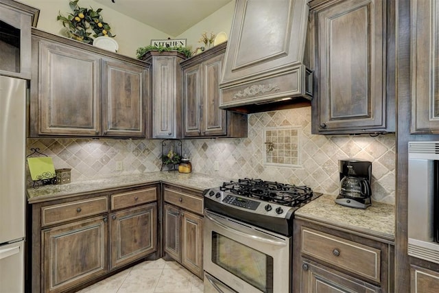 kitchen featuring backsplash, stainless steel appliances, and light stone counters