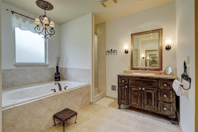 bathroom featuring tile patterned floors, vanity, independent shower and bath, and a notable chandelier