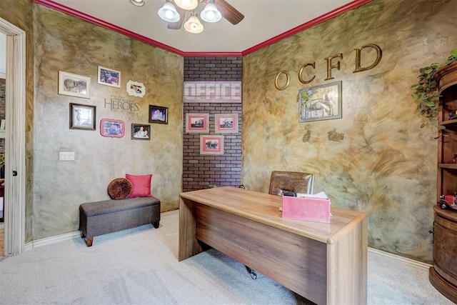 carpeted office featuring ceiling fan and crown molding