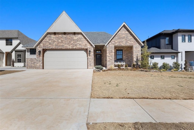 view of front facade featuring a garage, brick siding, concrete driveway, and a shingled roof