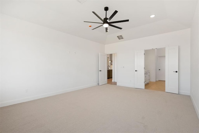 unfurnished bedroom with visible vents, baseboards, ceiling fan, light colored carpet, and lofted ceiling