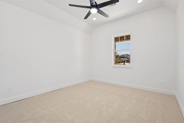 empty room featuring recessed lighting, light colored carpet, baseboards, and vaulted ceiling