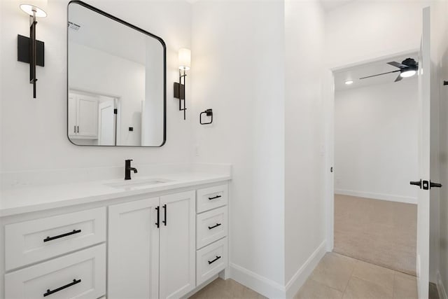 bathroom with visible vents, baseboards, tile patterned floors, vanity, and a ceiling fan