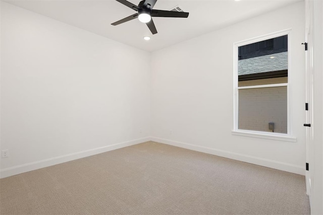 empty room with light carpet, ceiling fan, and baseboards