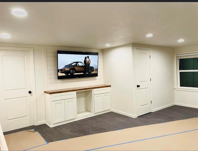 home theater room with built in desk