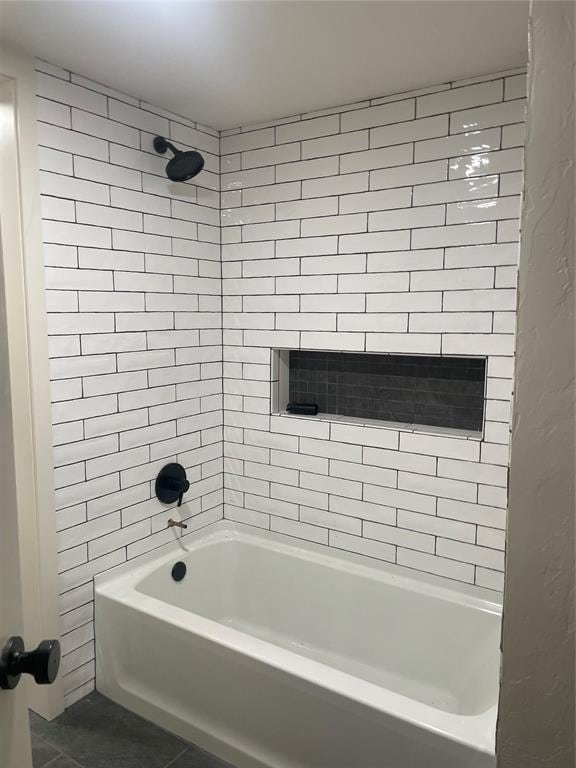 bathroom with tile patterned floors and tiled shower / bath combo